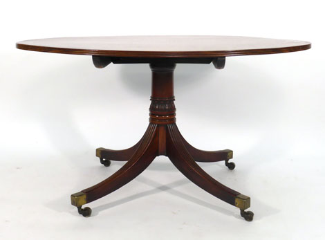 A Regency mahogany supper table, the oval top with reeded edge on a crisply moulded support with