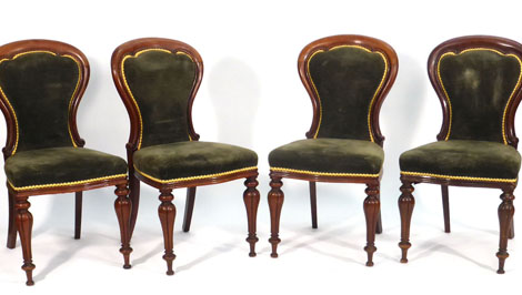 A set of eight Victorian mahogany framed dining chairs with upholstered spoon shaped backs and seats