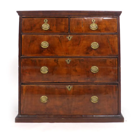 An early 18th century walnut and crossbanded chest of three graduated long and two short drawers