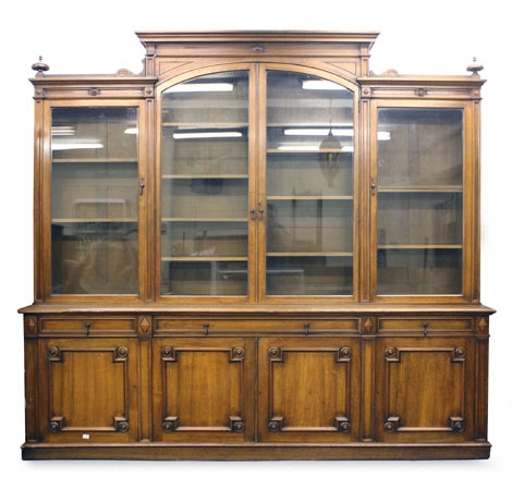 A late 19th century walnut library bookcase, with four glazed doors over an arrangement of four