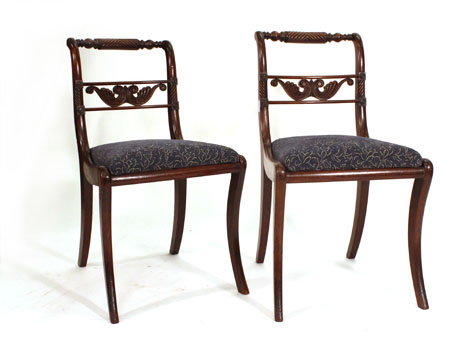 A pair of Regency mahogany dining chairs with scroll moulded backs on sabre-legs   CONDITION REPORT: