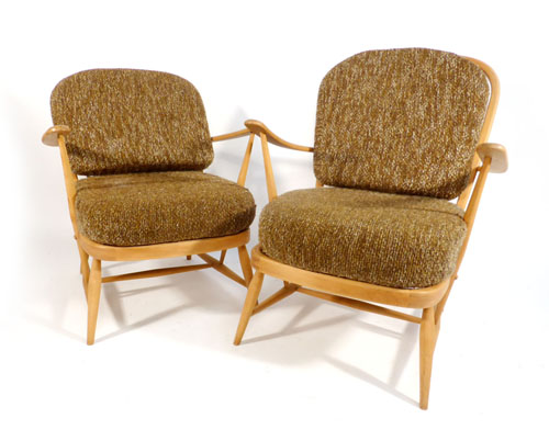 A near pair of elm and beech framed Ercol lounge chairs with brown upholstery    CONDITION