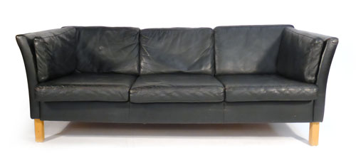 A black leather three seater sofa on beech legs, in the manner of Borge Mogensen    CONDITION
