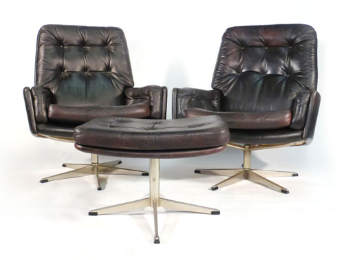 A pair of 1970s black leather swivel bucket chairs on aluminium five star bases with a matching