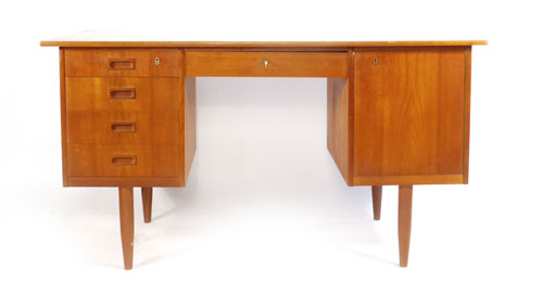 A Danish teak twin pedestal desk with an arrangement of five drawers and one cupboard, l. 134.5 cm