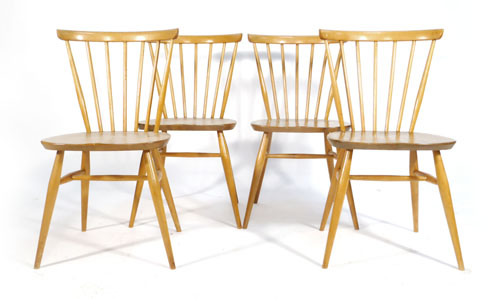 A set of four Ercol elm and beech spindle back dining chairs   CONDITION REPORT:  Generally good