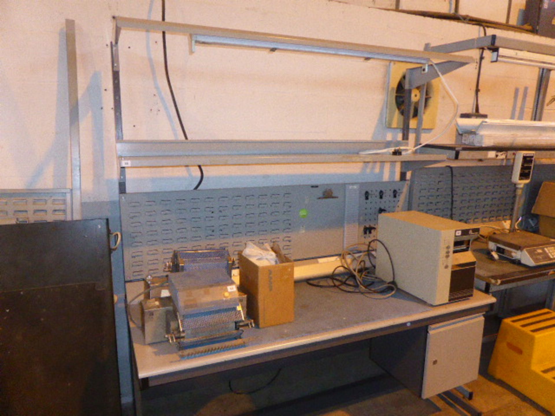 3 electronic engineers test benches together with a similar disassembled unit, 2 cherry pedestals