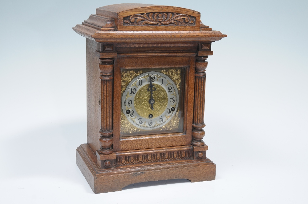 A Victorian walnut cased bracket clock with a 13cm silvered chaptering with brass leaf and scroll