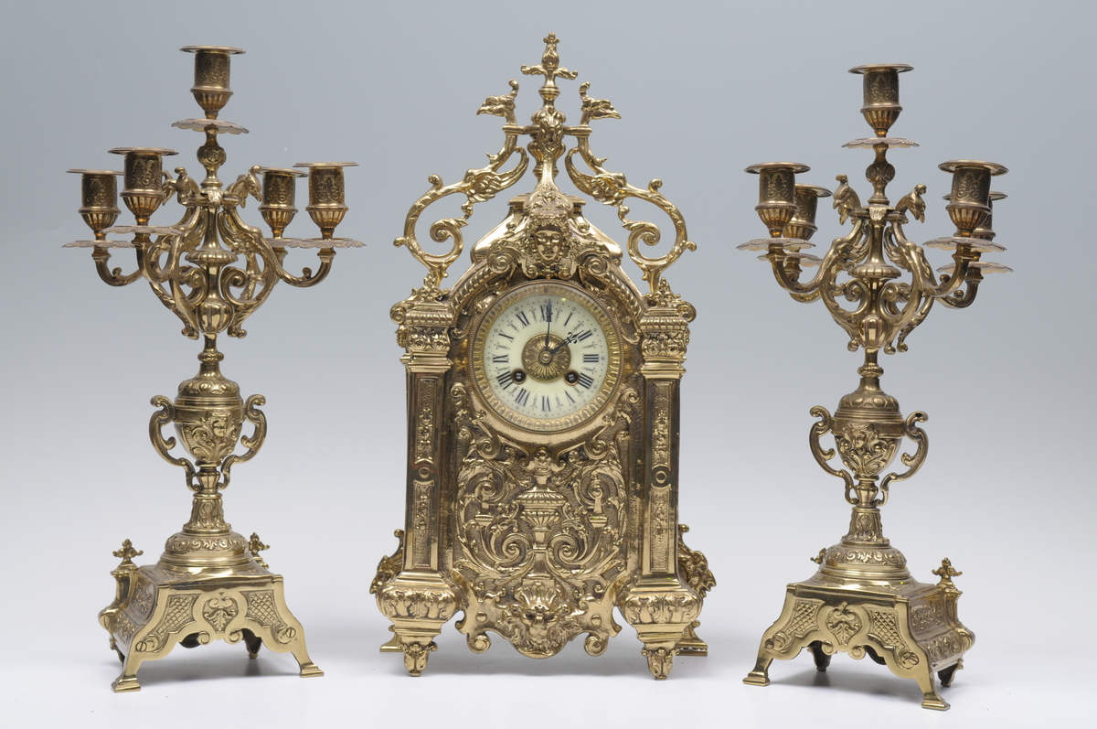 A French gilt brass clock garniture, the mantle clock with a 9cm white dial with Roman numerals, the