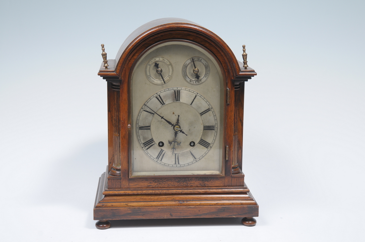 A late 19th early 20th century oak bracket clock with a 14cm silvered chaptering with subsidiary