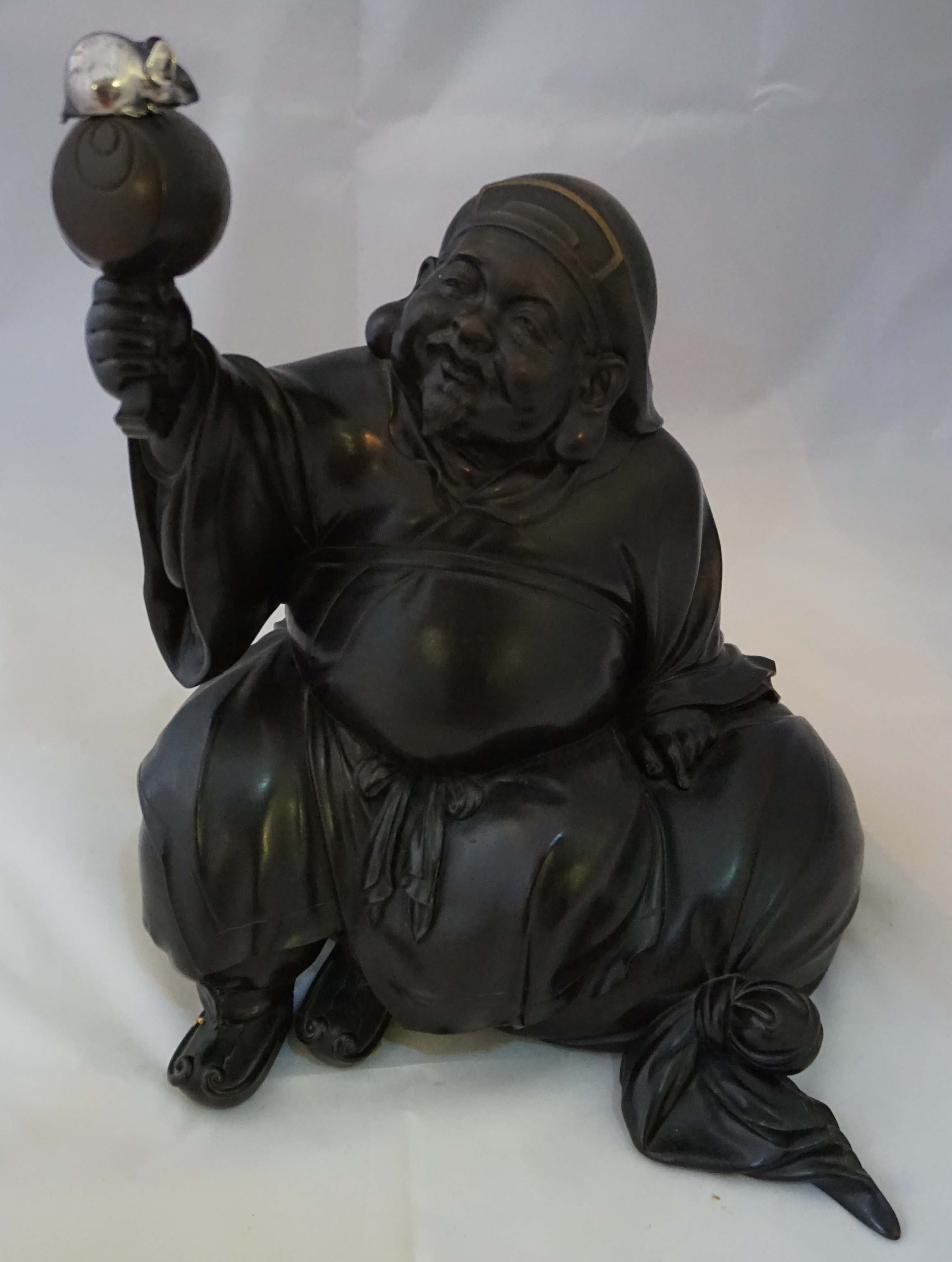 A Japanese bronze figure of Ebisu, 20th century, the god of fisherman and merchants dressed in robes