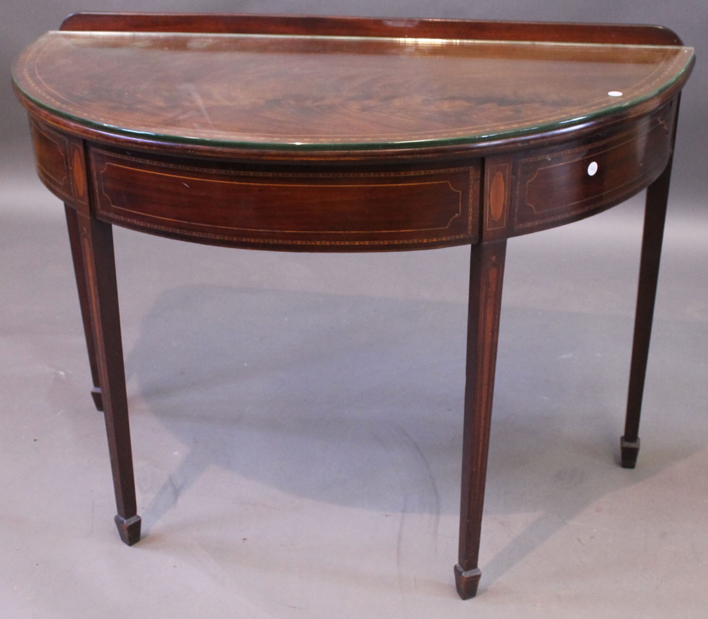 A 19th century inlaid mahogany semi circular side table, decorated with checkered banding, oval