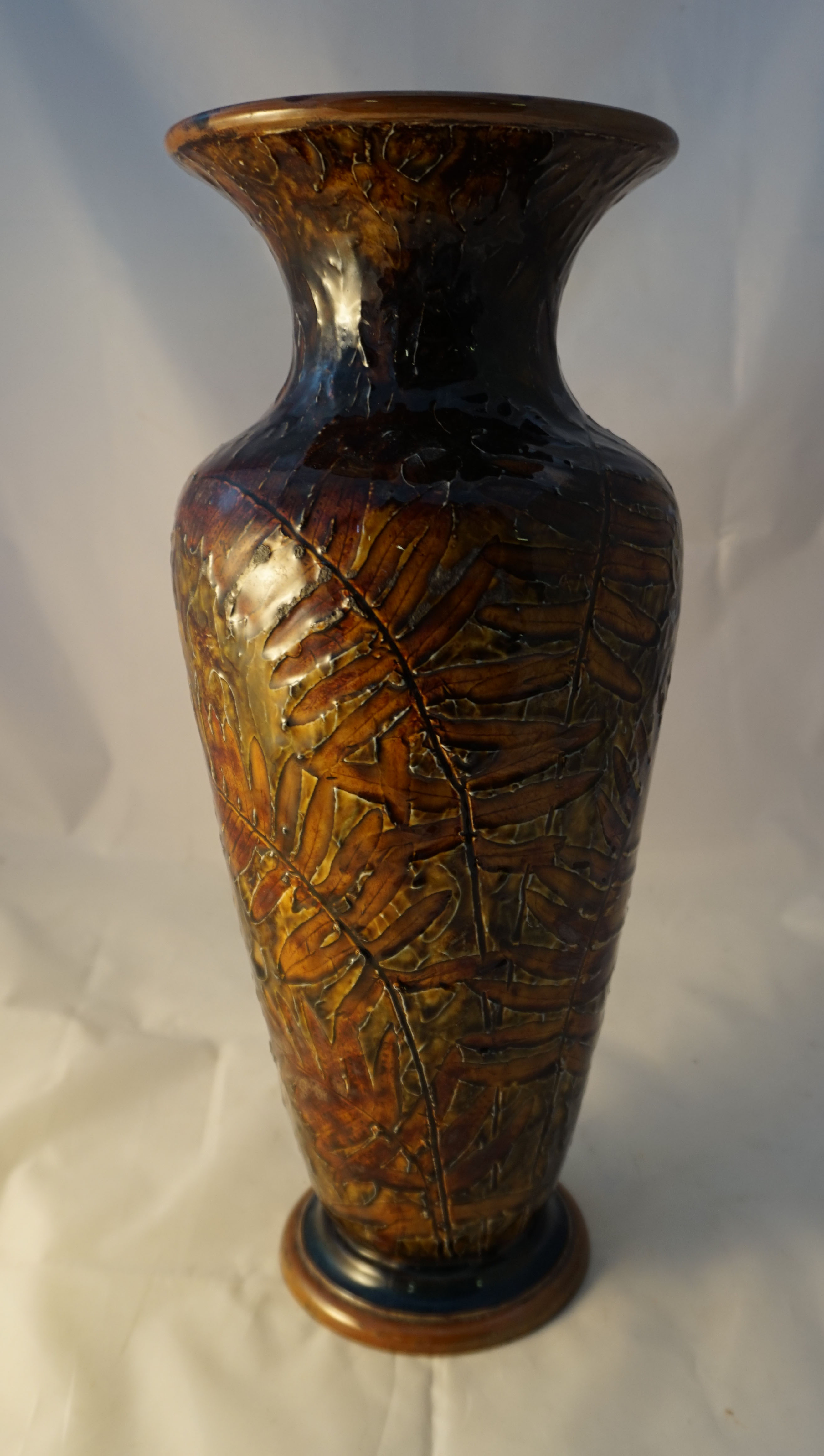 A Royal Doulton Art ware vase in the Natural Foliage series, decorated on a treacle glazed ground,