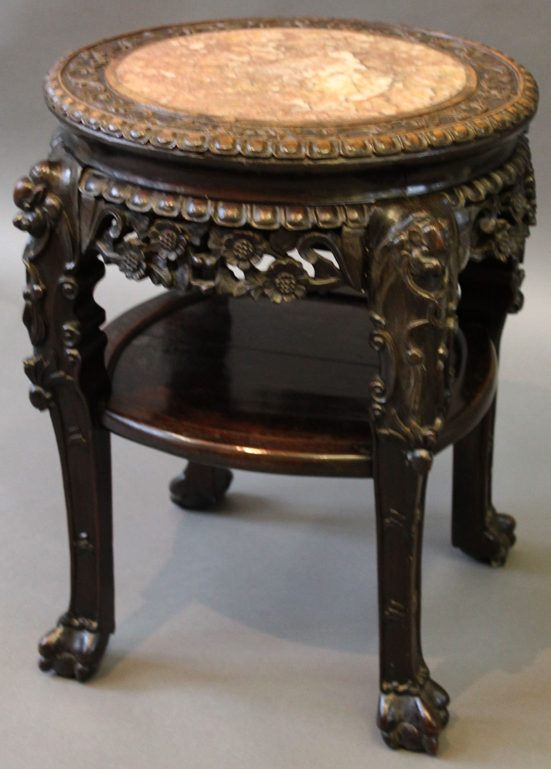 A Chinese hardwood and marble topped jardinière stand, late Qing dynasty (1644-1912), the circular