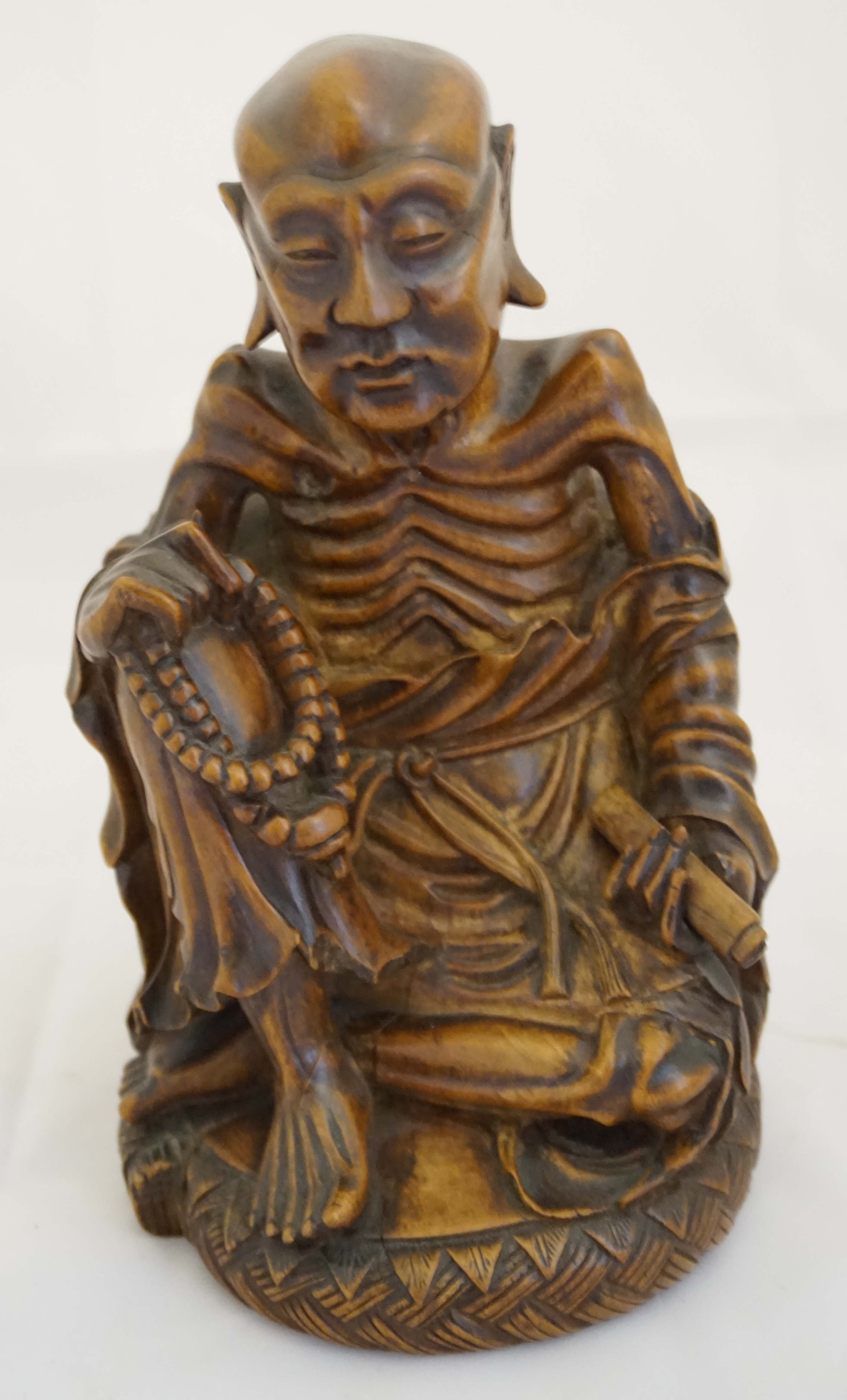 A Chinese carved rootwood figure of a Luohan, first half 20th century, the well carved figure