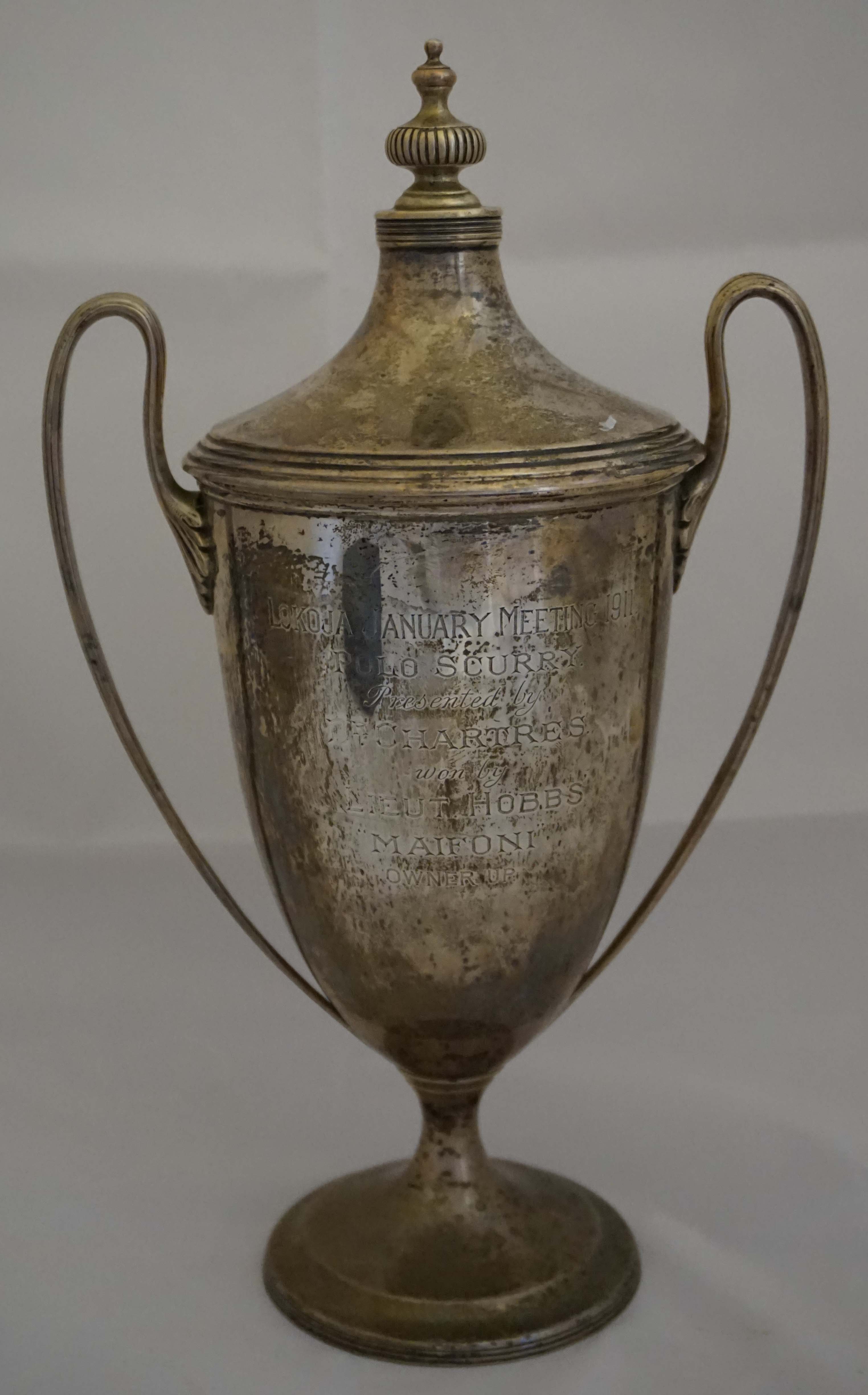 A Edward VII hallmarked silver twin handled pedestal trophy cup and cover, having central