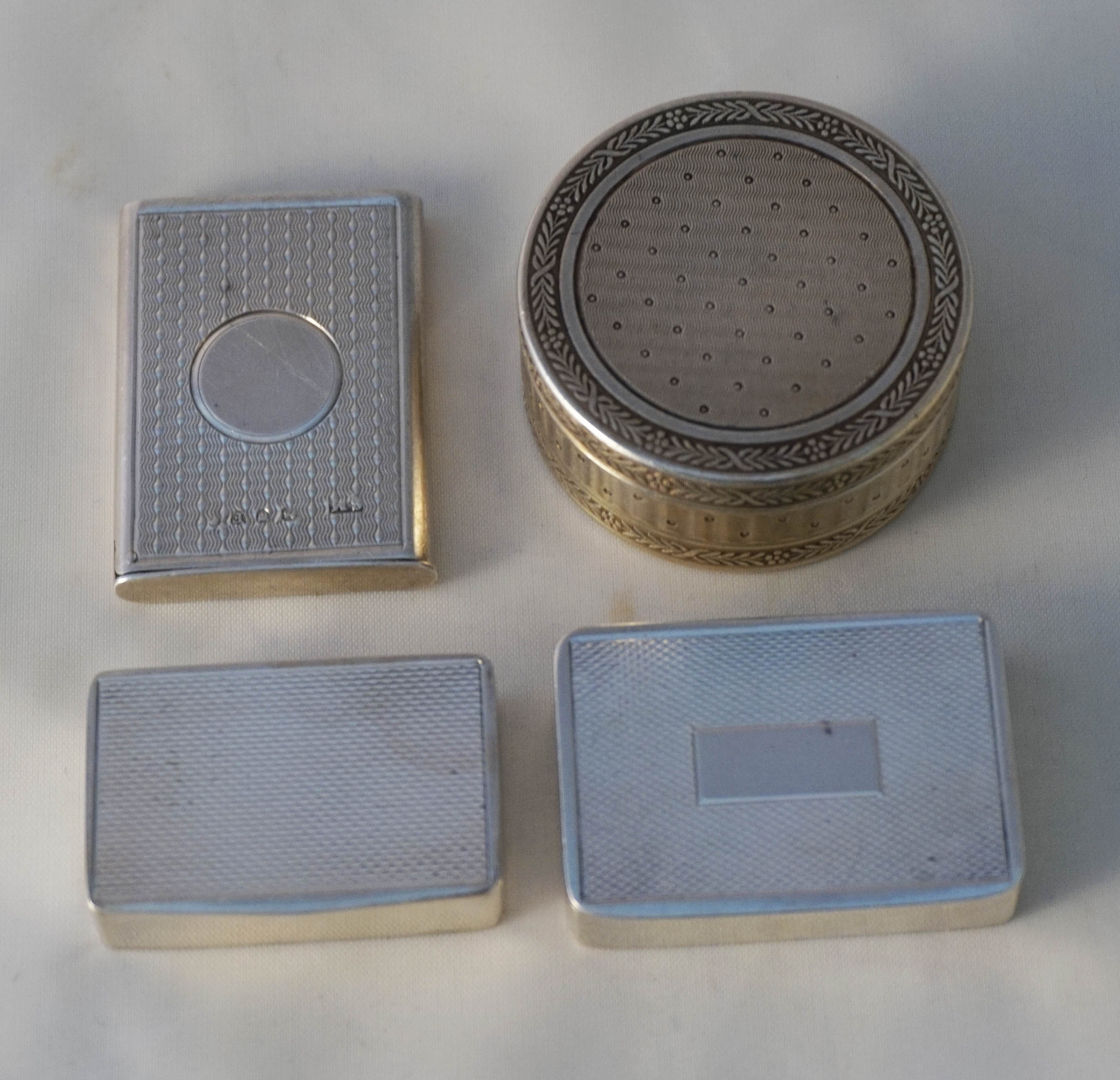 A collection of four Victorian and later hallmarked and continental silver snuff, pill and vesta