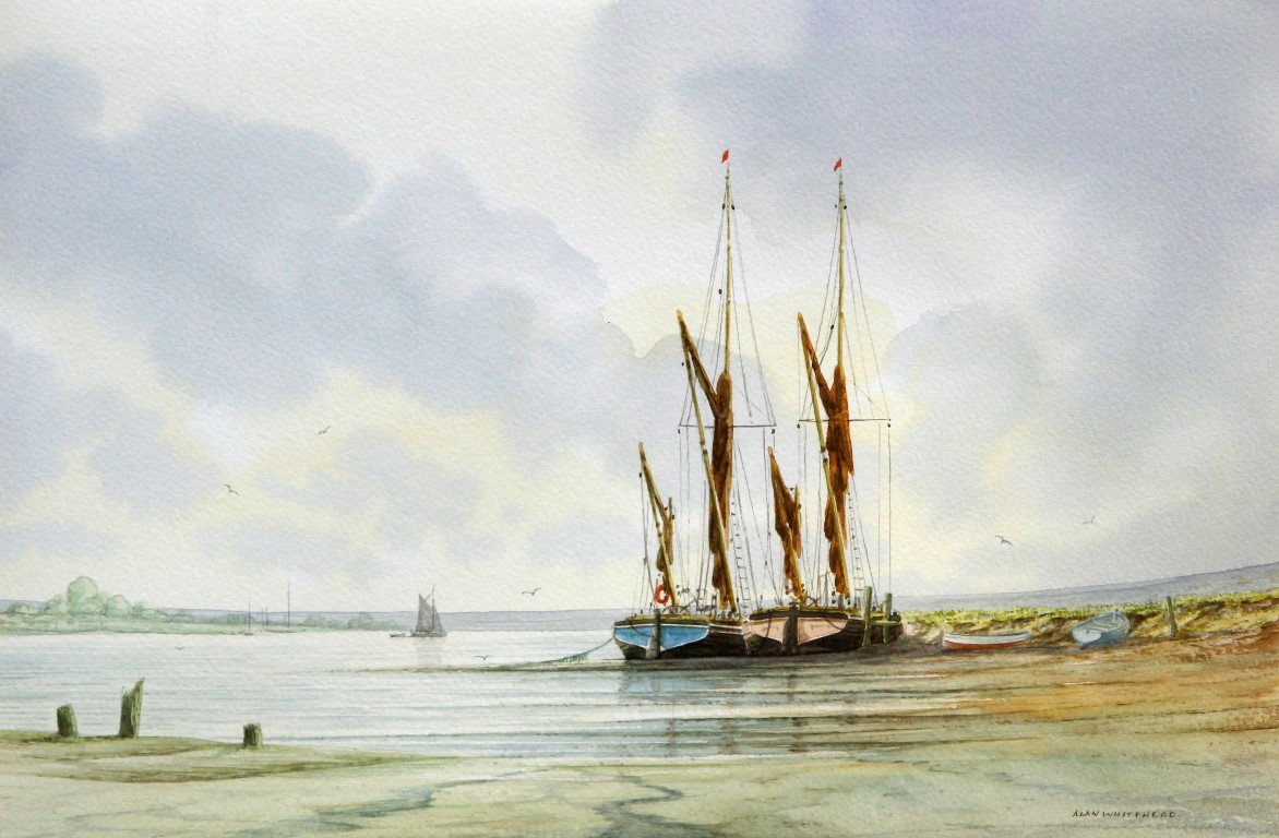 Alan Whitehead (British b.1952), a watercolour 'Low tide on an estuary' depicting barges,