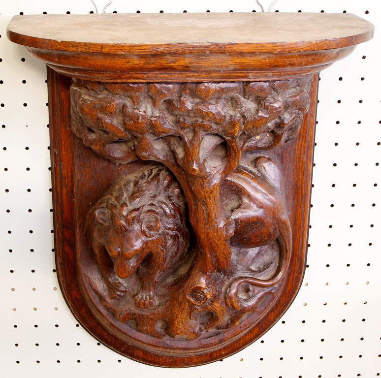 An early 20th century wall bracket, the upper semi-circular tier stepped form with heavily carved