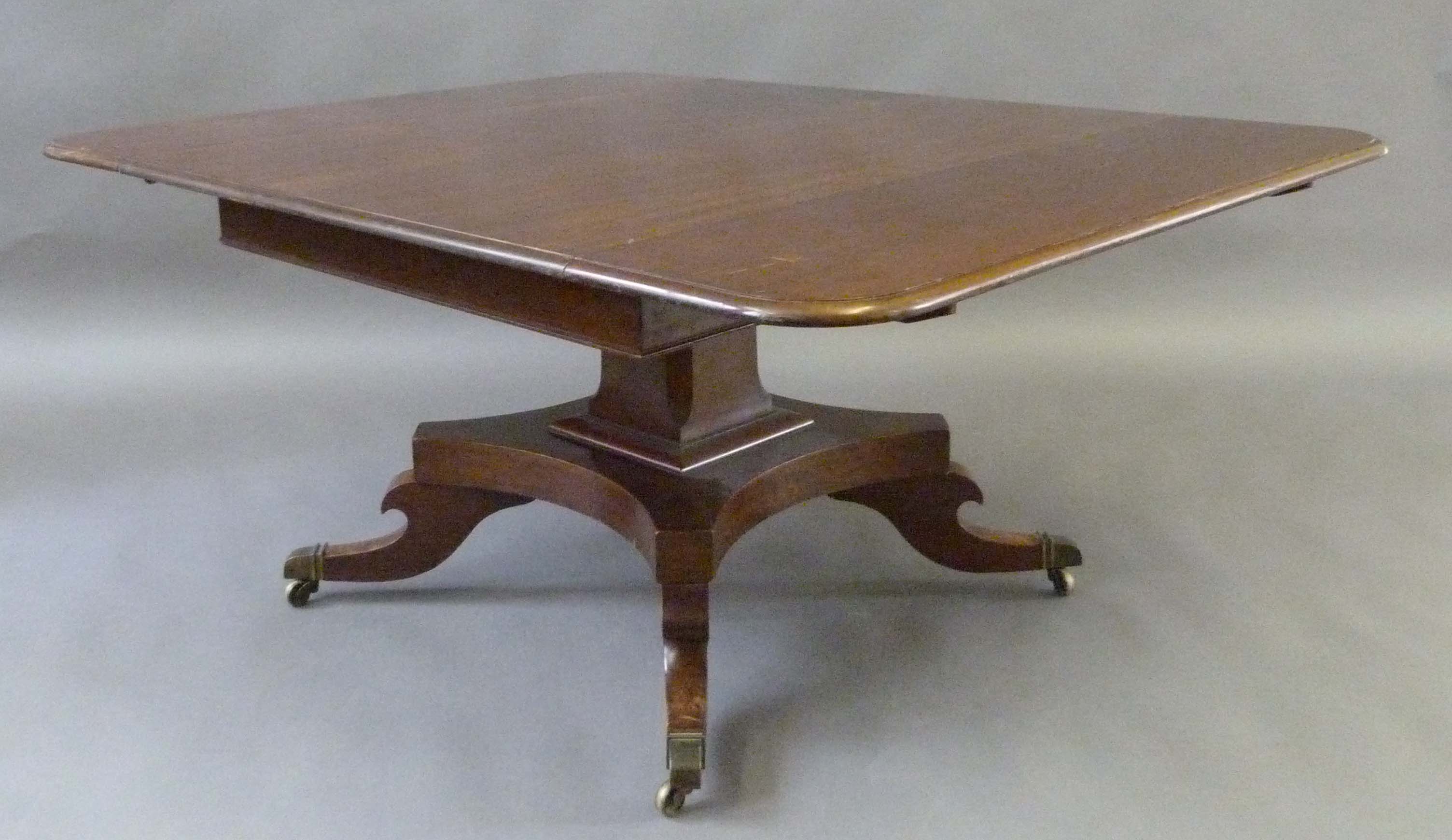 A Regency period mahogany table with two additional leaves, raised on column square and