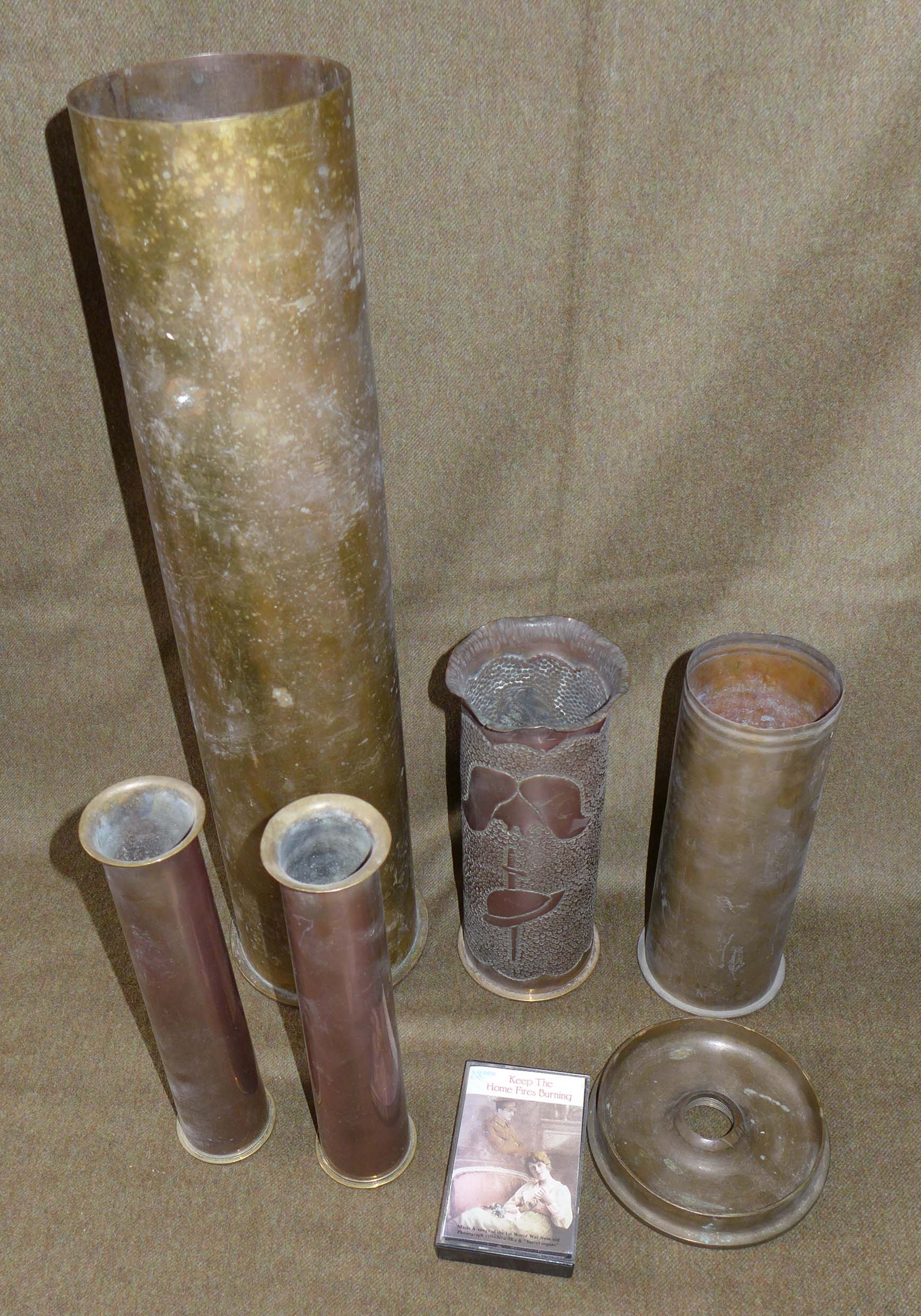 An Imperial German shell case, height 50cm, a pair of World War II shell cases made into vases,