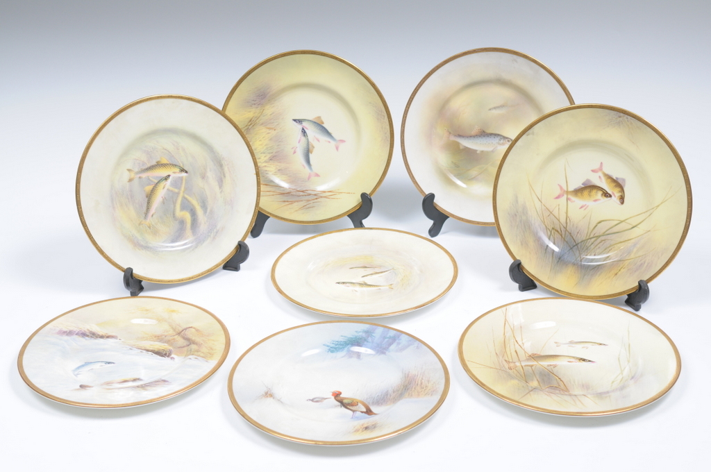 SEVEN ROYAL DOULTON DESSERT PLATES, painted with fish, one signed N Newton, another, N Perry, six