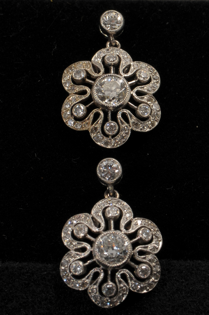 A PAIR OF ATTRACTIVE STYLISED DIAMOND CIRCULAR SNOWFLAKE CLUSTER EARRINGS, circa 2010. Each with a