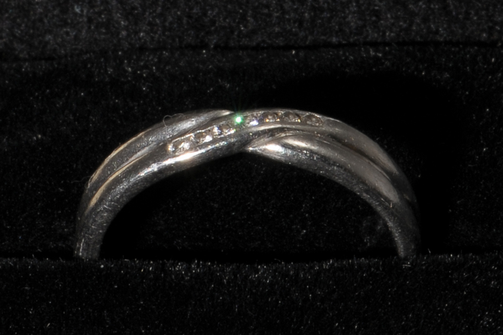 A PLATINUM AND DIAMOND WEDDING RING, Birmingham 2003. Cross-over design with a single line of