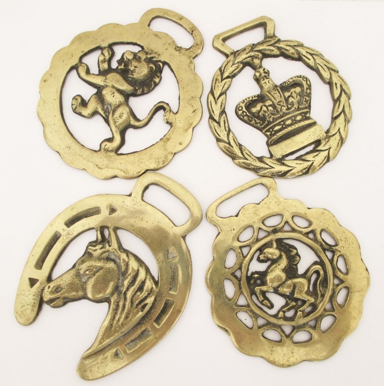 FOUR EARLY 20TH CENTURY HORSE BRASSES Horse harness brasses