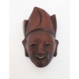 CHINESE CARVED ROSEWOOD JOVIAL MASK Rosewood mask with ivory teeth. Approx 2.75 inches tall