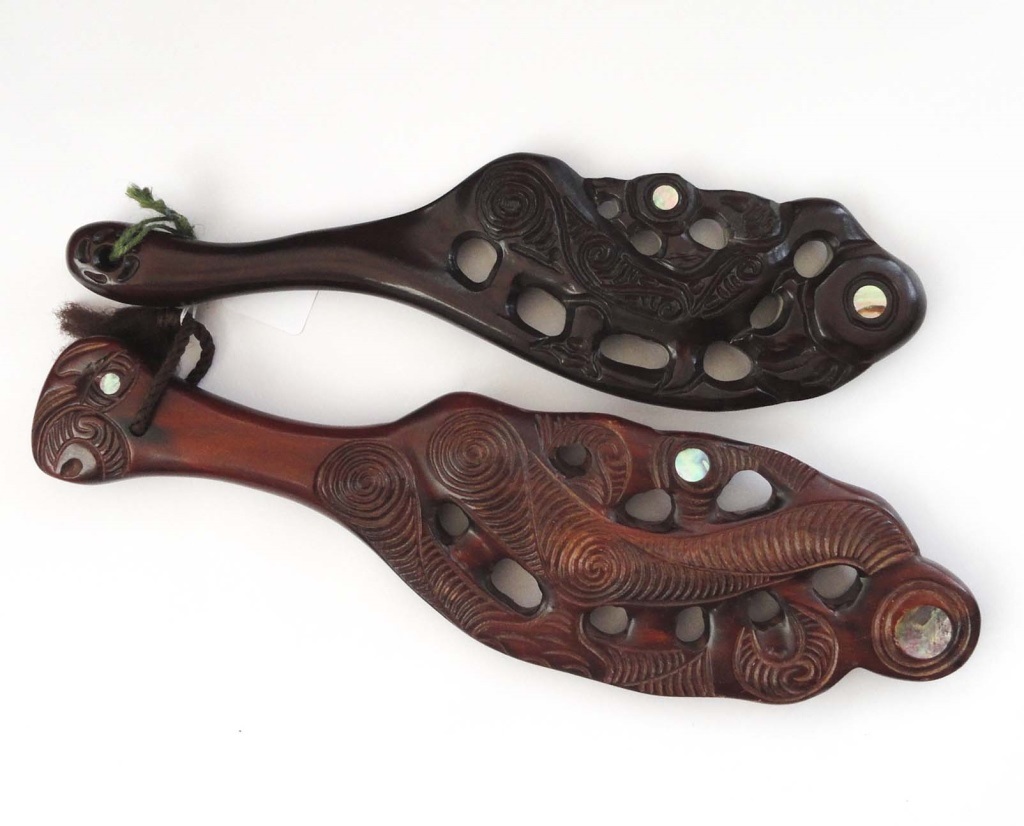 TWO PIERCED MAORI WAR CLUBS Two hard wood clubs with mother of pearl inlay.