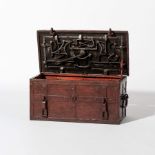 A brown lacquered wrought iron strongbox