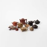 Eleven Yixing teapots with lids