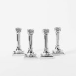 A set of four silver column candlesticks