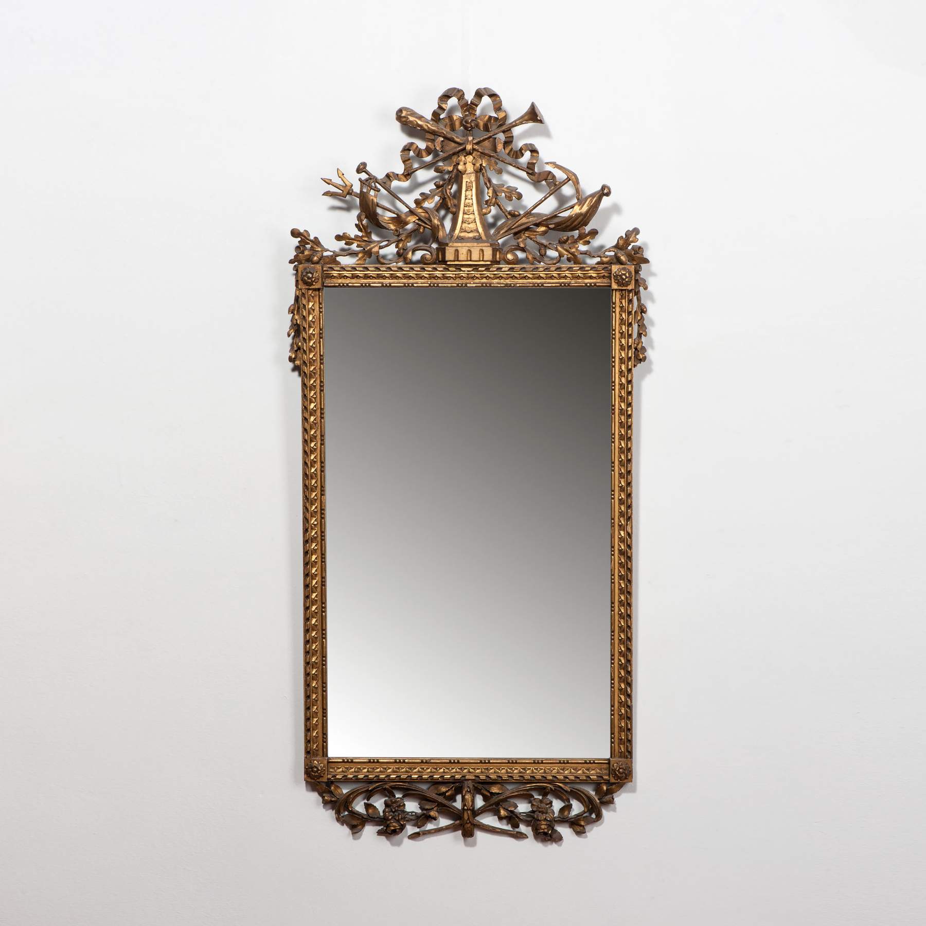 A large rectangular Louis XVI mirror in gilded wooden frame