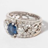 An 18 carat white gold, diamond and sapphire ring  20th century Centred by an oval faceted blue