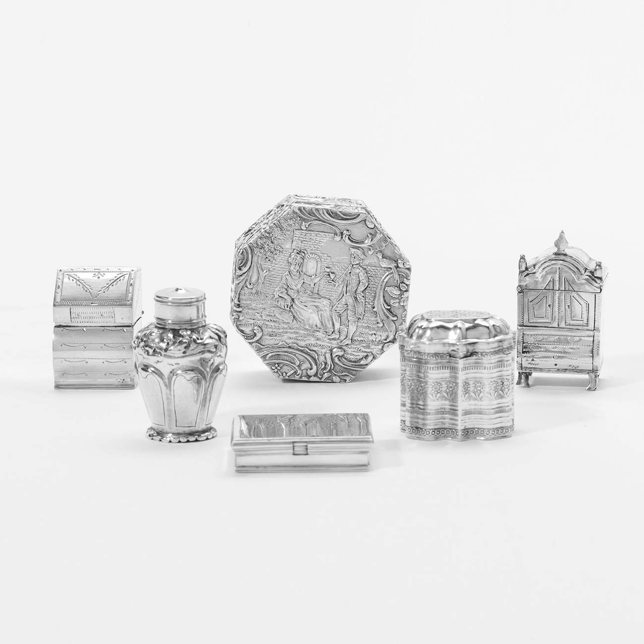 Three silver lodderein boxes, a silver pillbox, a silver miniature tea caddy with lid and a silver