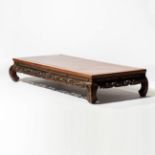 A rectangular elm opium bed  China, circa 1900 The front and sides openwork. Curved feet. H. 34 x W.