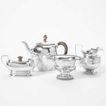 A silver teapot with lid, a silver creamer, a silver sugar bowl with lid and a silver bonbonière
