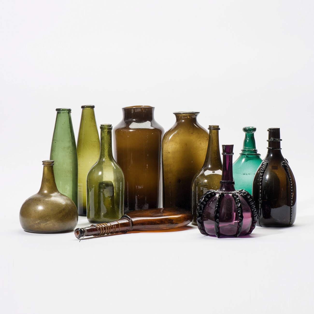 A combined lot glassware  18th century and later Including a flat brown Iranian bottle with glass