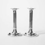 A pair of silver empire candlesticks Nicolaas van Voorst, Utrecht, 1818 Ribbed shaft, oval foot.