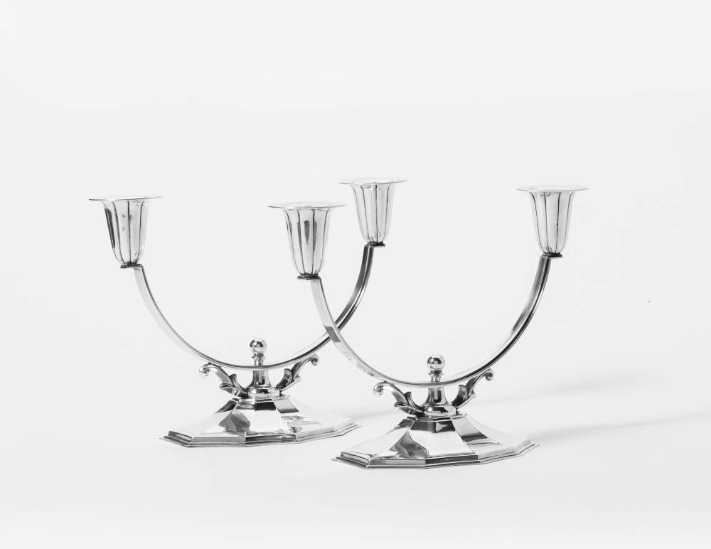 A pair of Danish silver two-light candelabra Copenhagen, 1934, Jens Sigsgaard The ten-sided foot