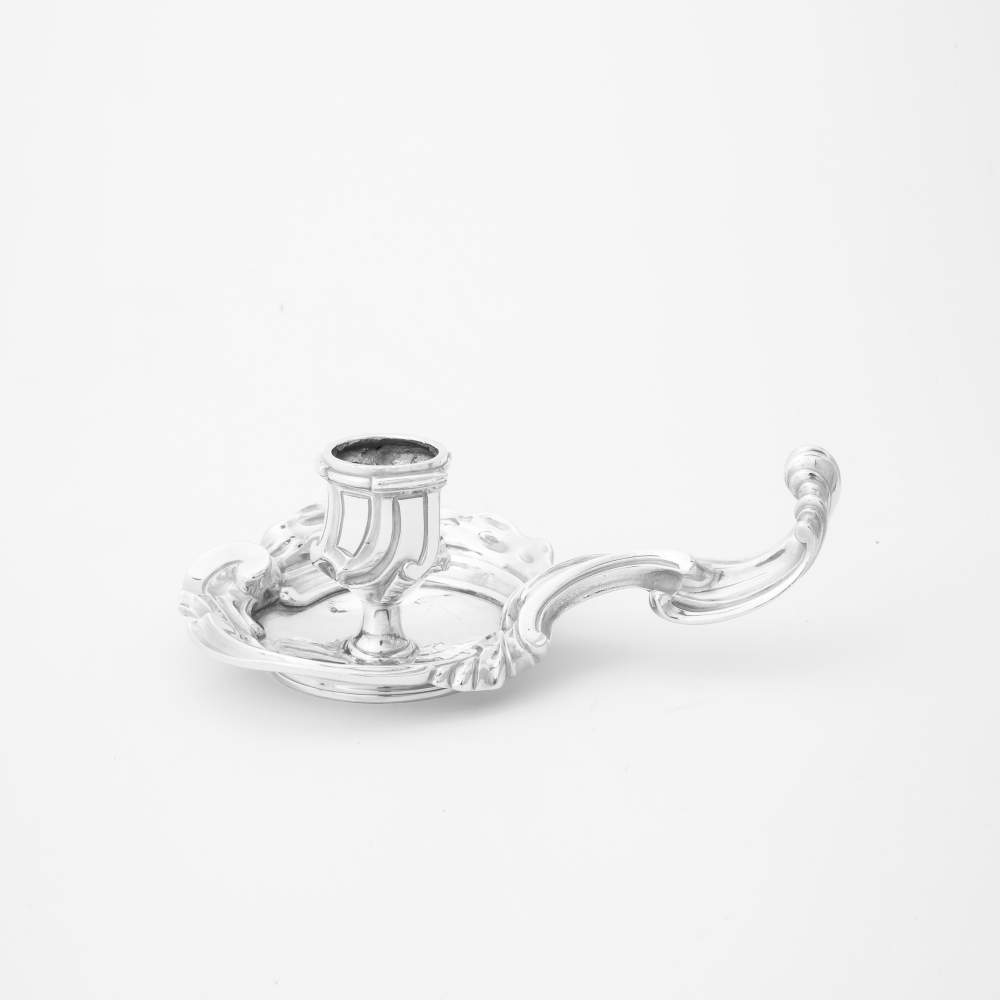 A silver rococo candlestick Paris, circa 1750, unclear maker's mark The curved handle with C-