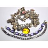 A white metal charm bracelet with attach