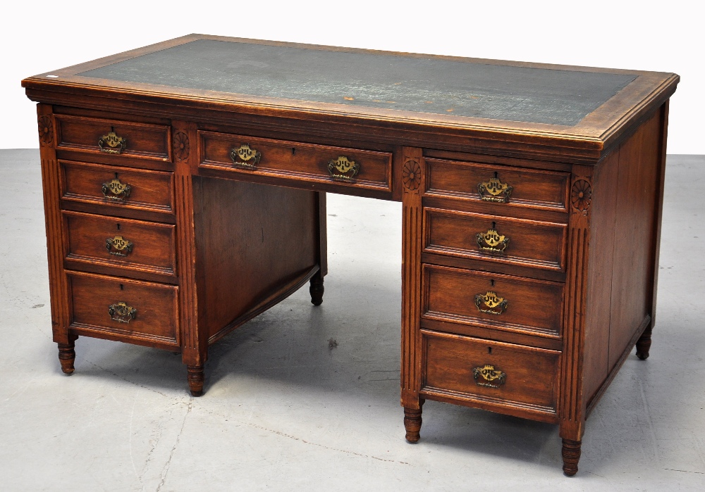 An Edwardian oak nine drawer twin pedest