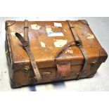 A vintage strap bound trunk with brass f