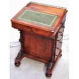 A 19th century Davenport desk, tooled leather inlay to the top, four side drawers and a hinged