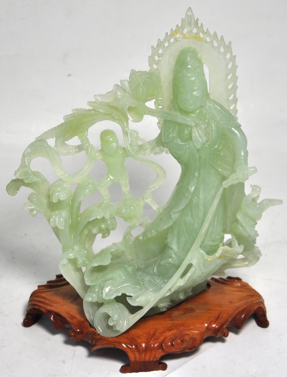 A polished green hardstone figure of a y