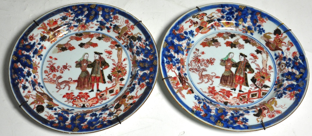 A pair of 19th century Chinese export plates decorated with figures in European dress and a border