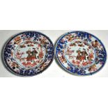 A pair of 19th century Chinese export plates decorated with figures in European dress and a border